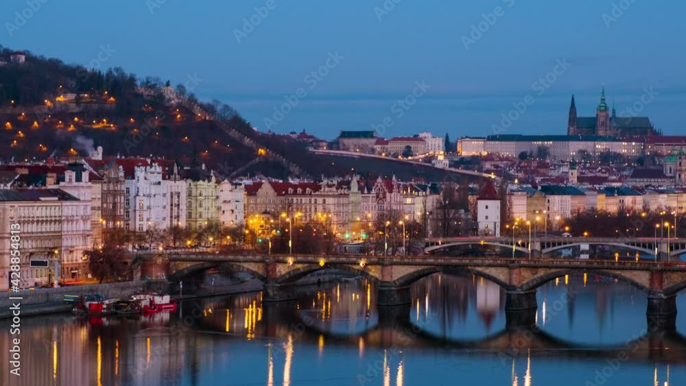Prague, Czech Republic. Jiraskuv Bridge over Vltava river in Prague, Czech Republic. Timelapse during the sunrise with Castle. Time-lapse of a cloudy sky from night to day, zoom in Prague, Czech Republic. Jiraskuv Bridge over Vltava river in Prague, Czech Republic. Timelapse during the sunrise with Castle. Time-lapse of a cloudy sky from night to day, zoom in