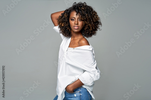 African american woman with afro wear white loose shirt isolated on gray background