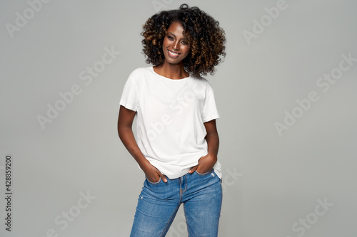 Sexy black woman with afro hair wear classic outfit isolated on gray background