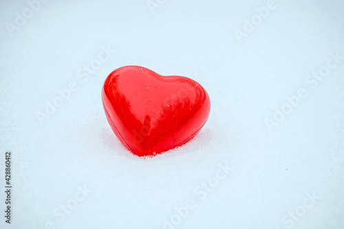 Box in the form of a heart in the snow in winter.Give a gift for valentine s day