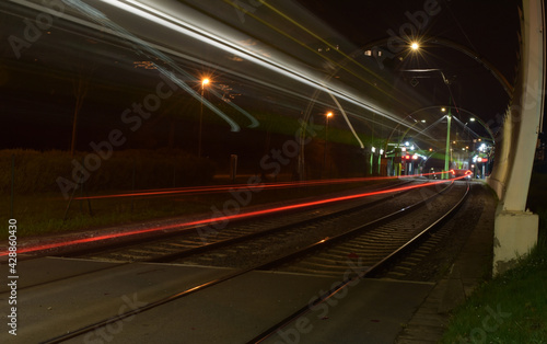Tram at night and blurred traffic, tram stop