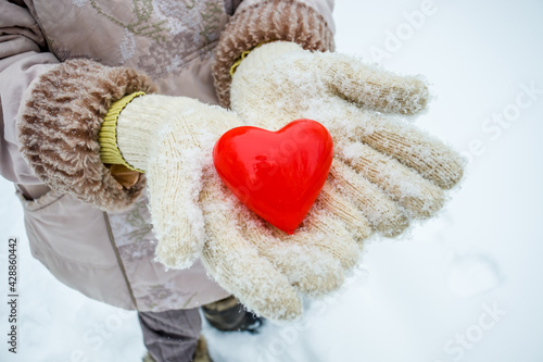 Box in the form of a heart in a hand in winter.Give a gift for Valentine s Day