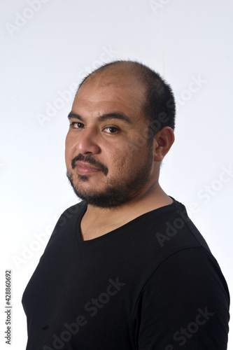 portrait of a latin man serious and looking at camera on white background