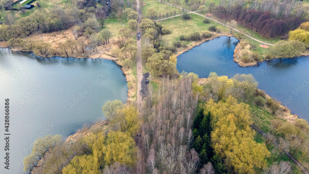 Aerial photography of the spring city park. The shore of the reservoir.