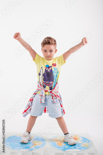 Funny cute little adorable caucasian boy posing in studio on white background