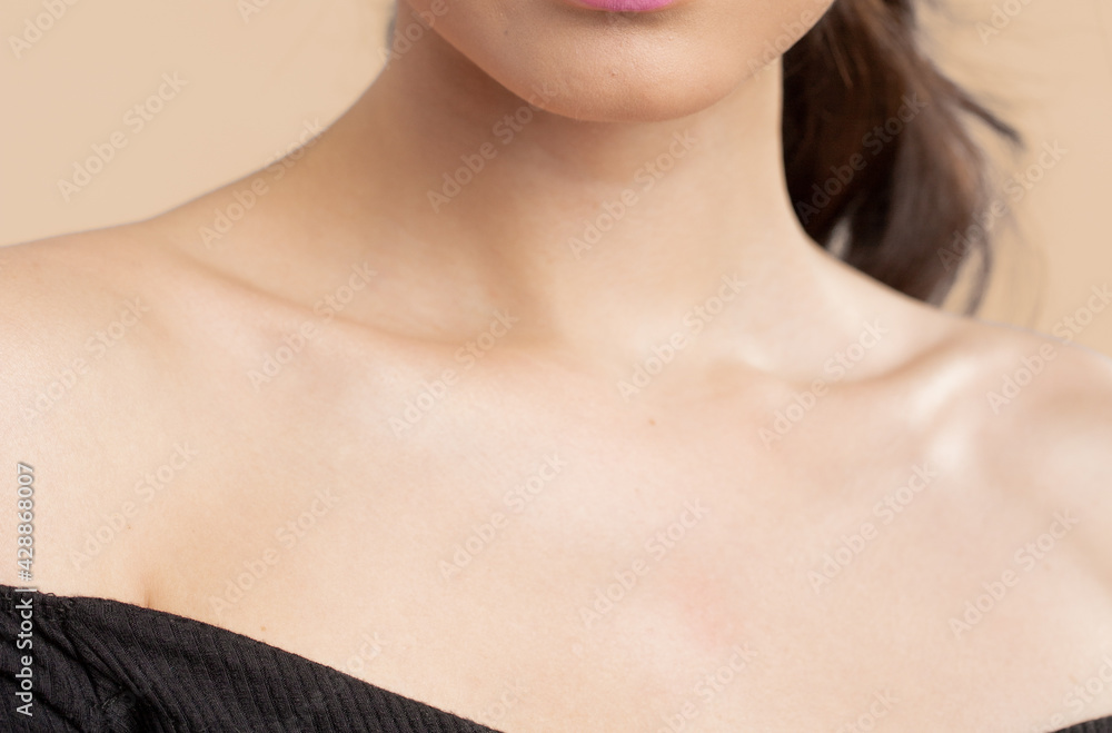 Women neck and shoulders on nude background Women neck and shoulders on nude background