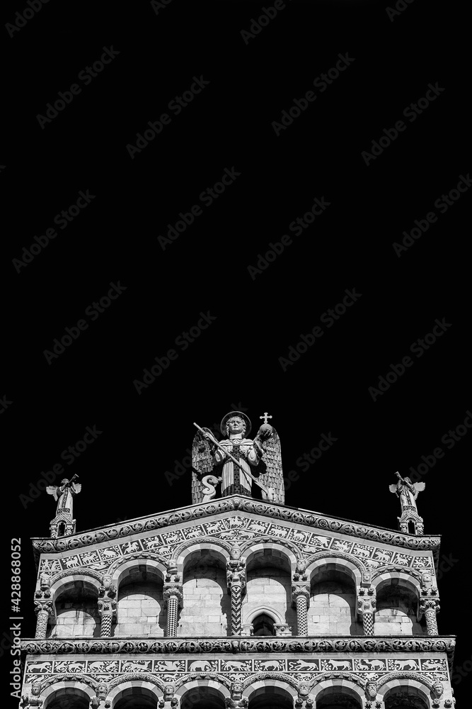 Fototapeta premium Saint Micheal in Foro Church beautiful medieval romanesque facade in the city of Lucca, Tuscany, erected in the 13th century (Black and White with copy space above)