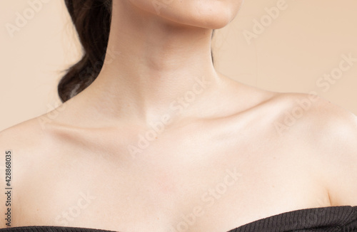 Women neck and shoulders on nude background