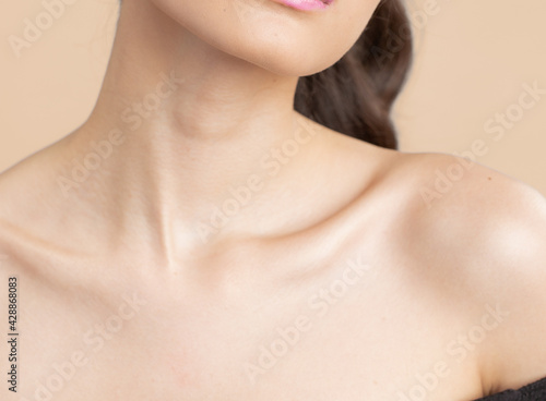 Women neck and shoulders on nude background
