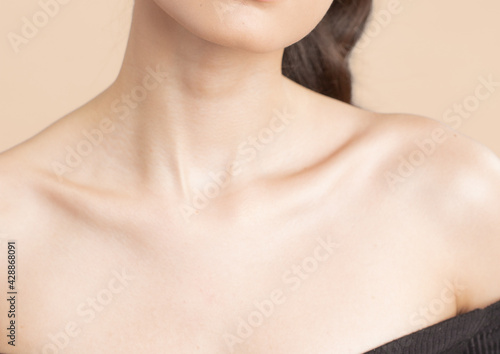 Women neck and shoulders on nude background