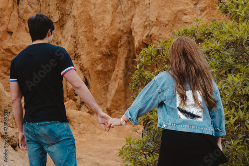 Back view of a couple holding hands at the Sabrinsky desert in Colombia