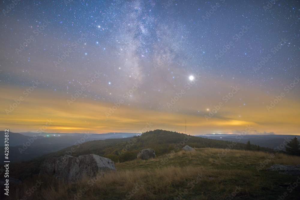 The Milky Way galaxy core rising over a mountainous landscape in West Virginia The Milky Way galaxy core rising over a mountainous landscape in West Virginia