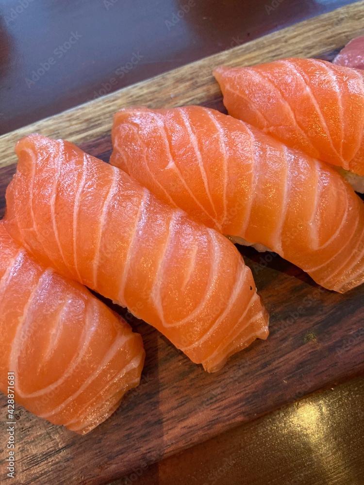salmon sushi on a wooden board
