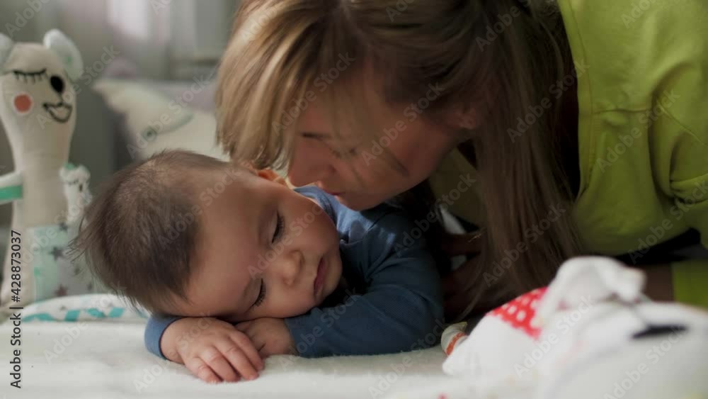 Mother cuddling and kissing baby boy. Mom enjoying with baby. Mother cuddling and kissing baby boy. Mom enjoying with baby.