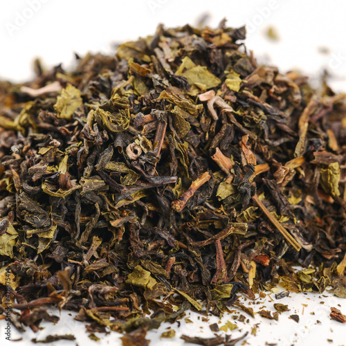 pile of loose green tea - dry green tea leaf isolated on white background