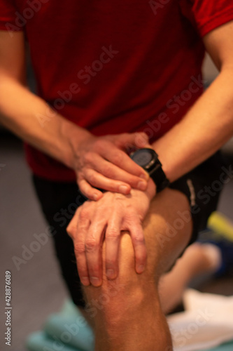 Man checking fitness tracker after finishing exercise © InspireGalleries