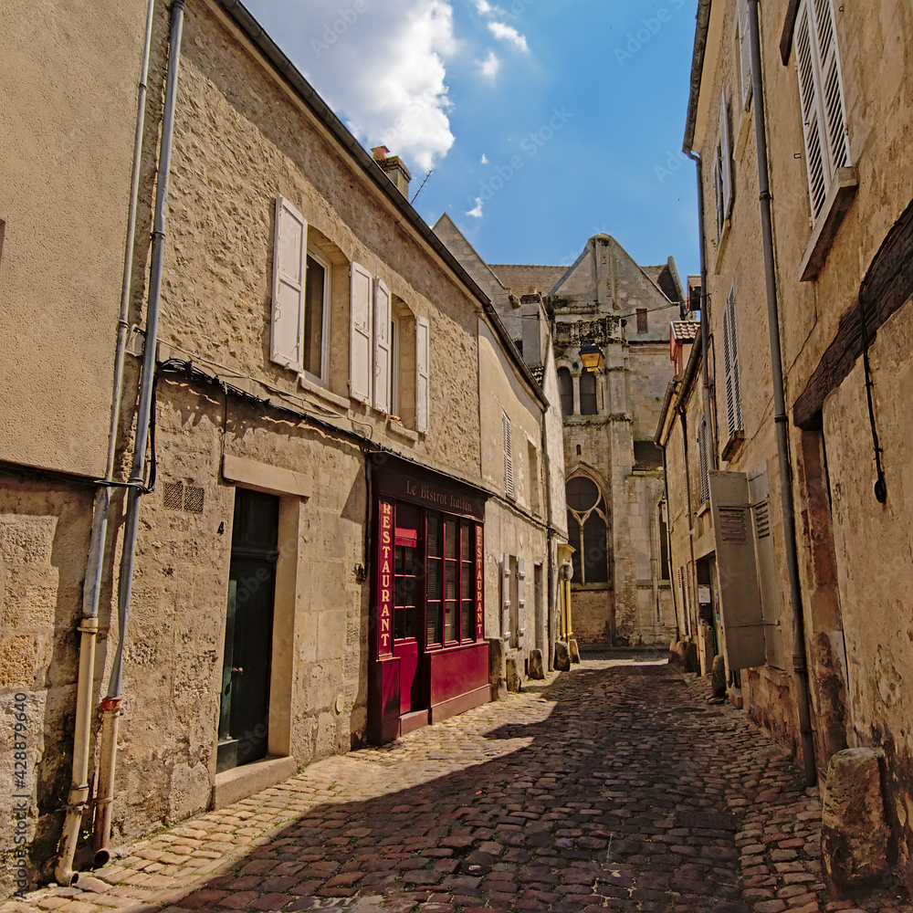 Cosy cobblestone street with old houses in Senlis, France