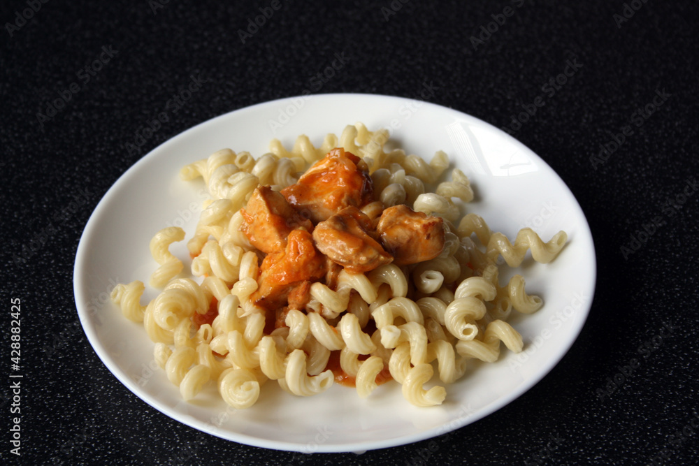 custom made wallpaper toronto digitalPasta with chicken in tomato sauce on a white plate. Chicken goulash with garnish.