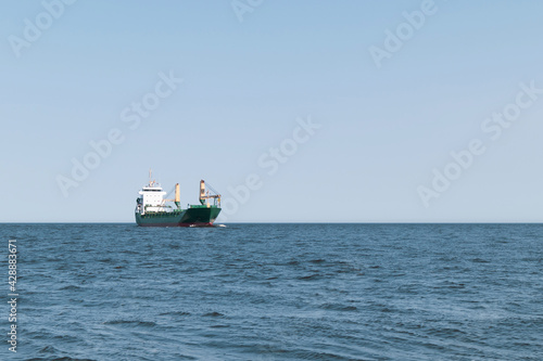 The cargo ship is sailing at sea