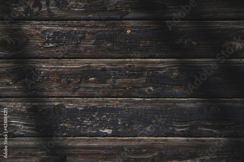 Old, burnt wooden wall. Dark background