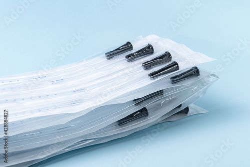 Rusch male and female all purpose catheter on blue background, straight tipped intermittent catheters designed for a single use, packaged individually and sterile, 10 inch