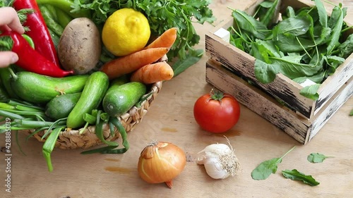  Fresh Vegetables in basket on wooden table.