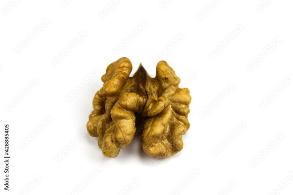 Half a walnut kernel on a white background. Walnut kernel isolated on white background. Peeled walnut on a white background. Piece of pulp of walnut. Half a walnut kernel on a white background. Walnut kernel isolated on white background. Peeled walnut on a white background. Piece of pulp of walnut.
