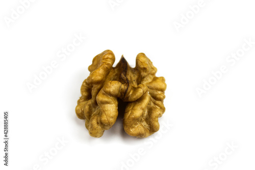 Half a walnut kernel on a white background. Walnut kernel isolated on white background. Peeled walnut on a white background. Piece of pulp of walnut.