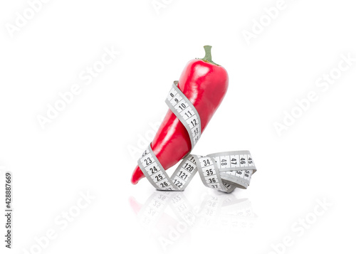 red pepper wrapped with measuring tape on white background