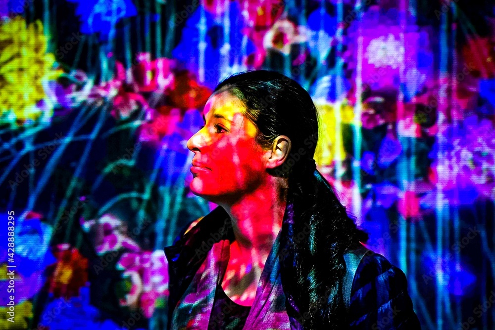 woman side portrait with projected images of flowers all over her woman side portrait with projected images of flowers all over her