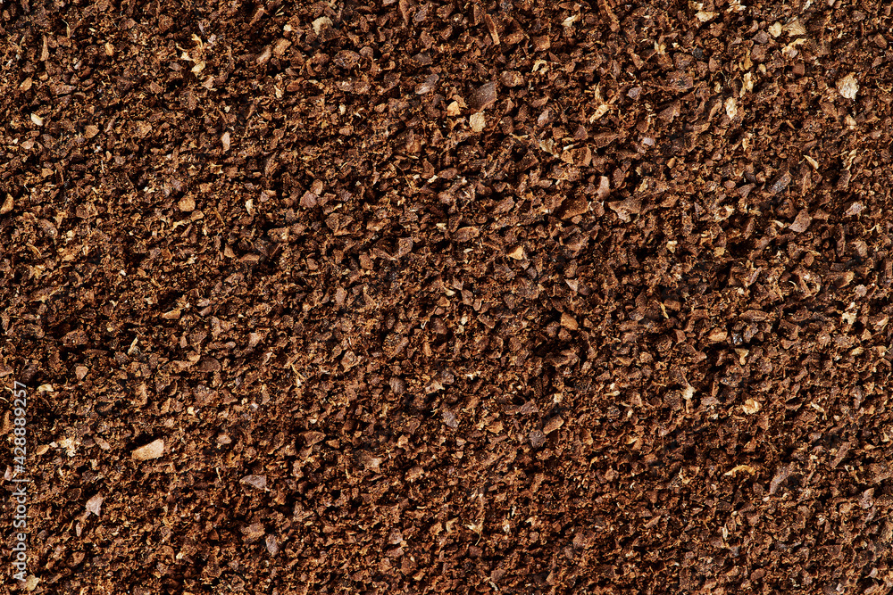 The texture of brown aromatic ground coffee. Macro view background with copyspace. The texture of brown aromatic ground coffee. Macro view background with copyspace.