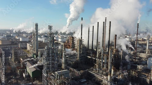 2020 - amazing rising aerial over a huge oil refinery along the Mississippi River in Louisiana suggests industry, industrial, pollution.  photo