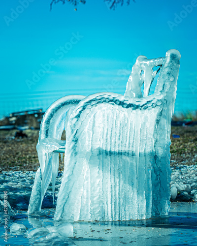 chair frozen in ice covered by winter storm photo