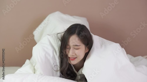 Funny Asian girl play on bed in bedroom at home