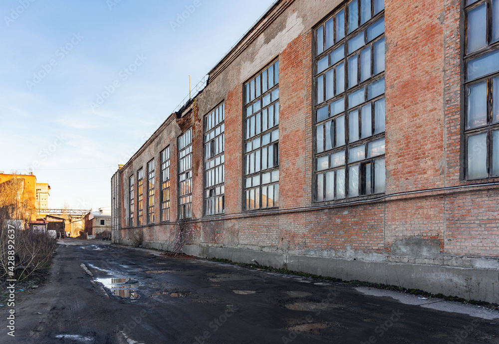 Old decaying factory building in disrepair, danger of wall collapse