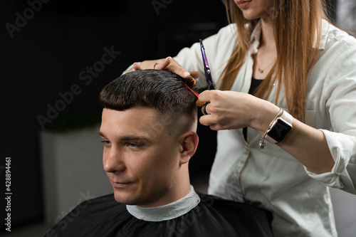 Barbershop service. Cutting hair. Hairstyle for handsome man.