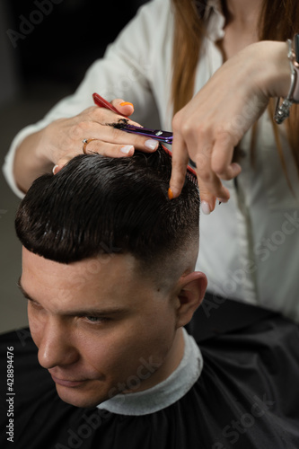 Barbershop service. Cutting hair. Hairstyle for handsome man.