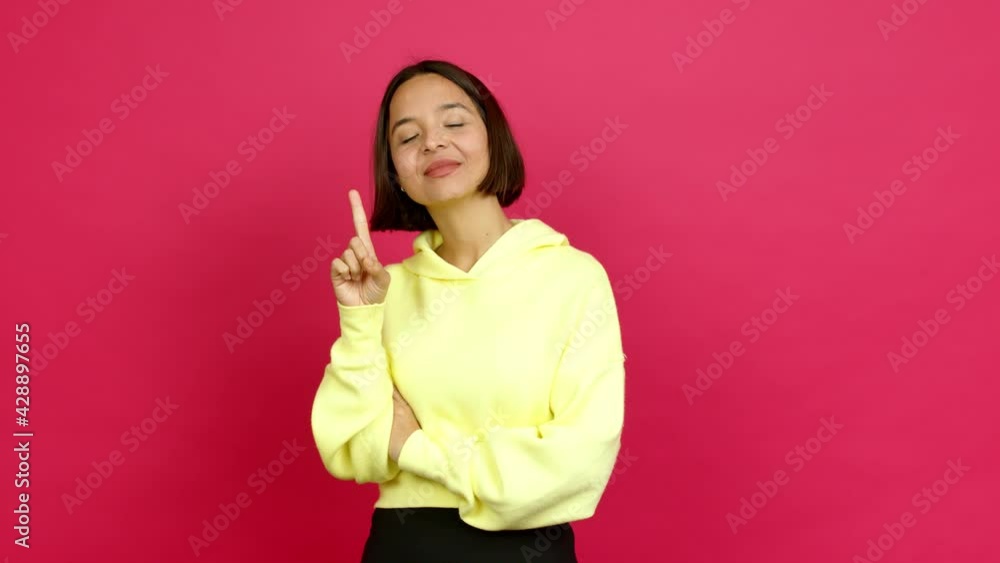 Young latin woman showing and lifting a finger in sign of the best over isolated background Young latin woman showing and lifting a finger in sign of the best over isolated background