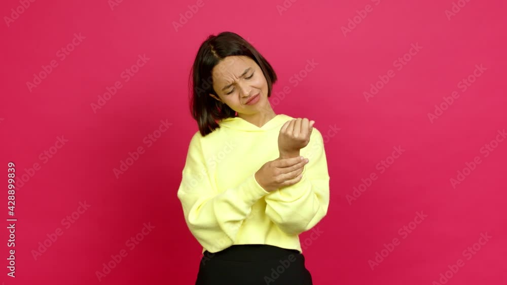 Young latin woman with pain in hand over isolated background Young latin woman with pain in hand over isolated background
