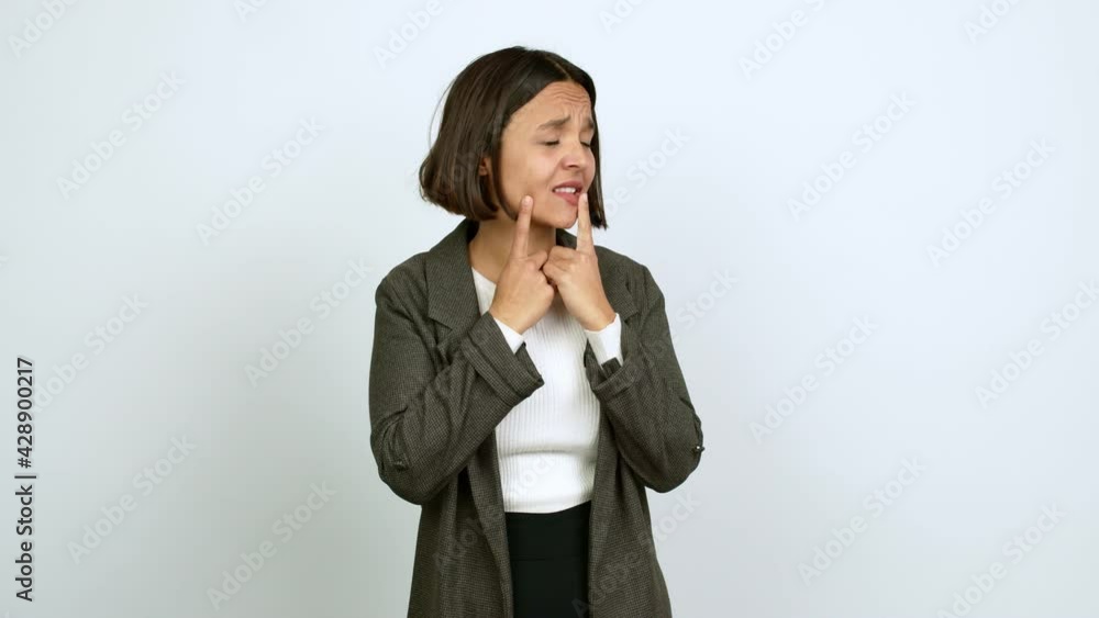 Young latin woman pointing to the laterals having doubts over isolated background Young latin woman pointing to the laterals having doubts over isolated background