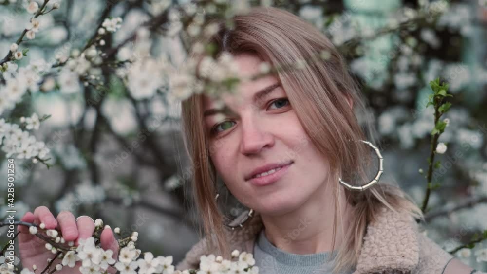 portrait of beautiful blonde woman in spring cherry blossom portrait of beautiful blonde woman in spring cherry blossom