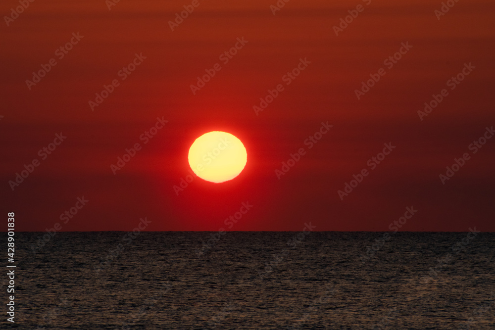Close up of the Sun rising out of The Atlantic Ocean at dawn