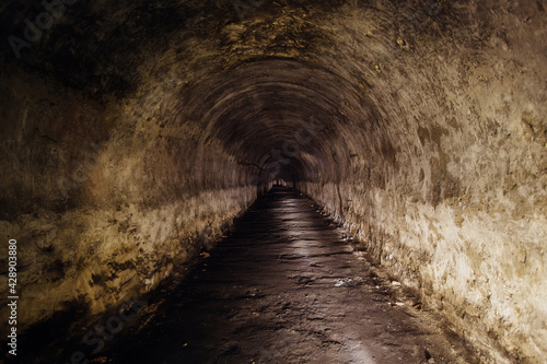 Tunnel with concrete walls in old abandoned Soviet bunker