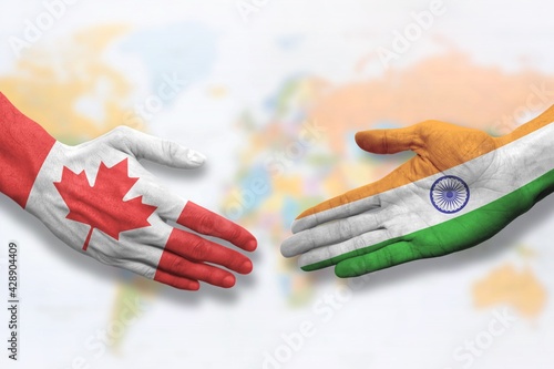 Canada and India - Flag handshake symbolizing partnership and cooperation