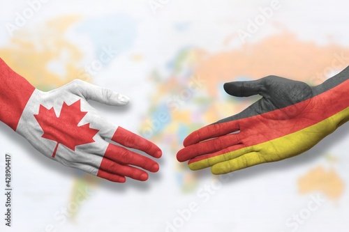 Canada and Germany - Flag handshake symbolizing partnership and cooperation