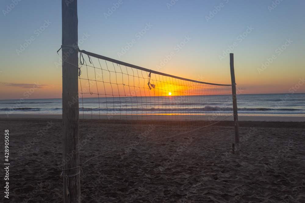 Volleyball court without players at sunrise.