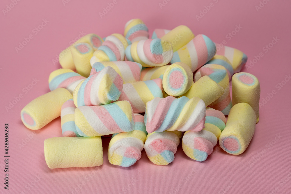 Colorful fluffy marshmallows on pile on pink background Colorful fluffy marshmallows on pile on pink background