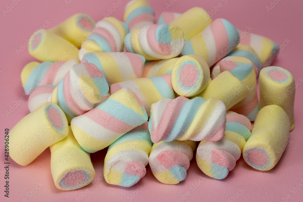 Colorful fluffy marshmallows on pile on pink background Colorful fluffy marshmallows on pile on pink background