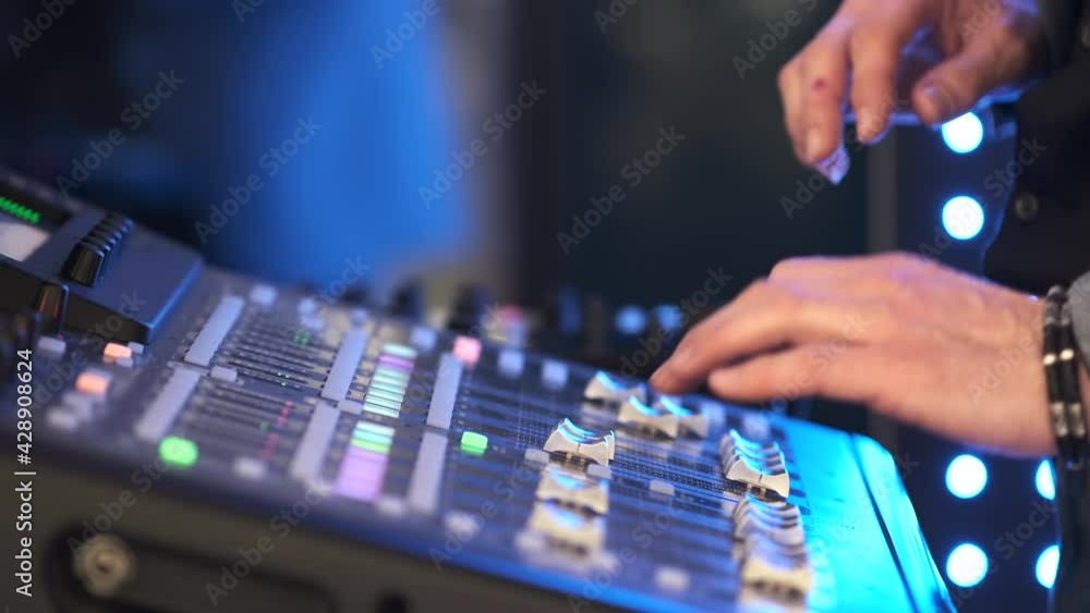 Slide audio mixer in the recording studio. Close up hand controls Audio