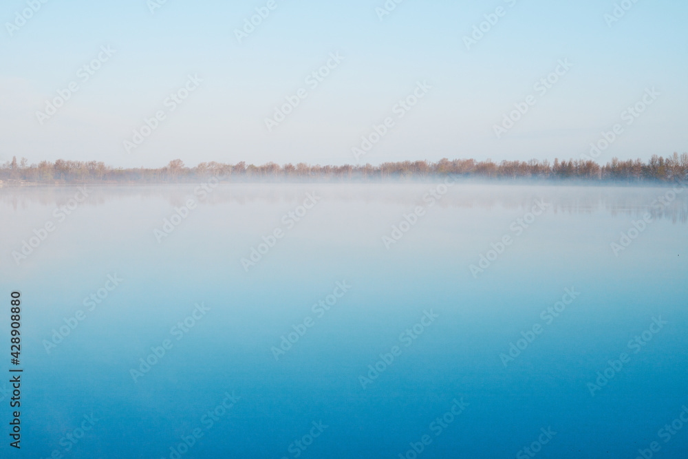 View of the river with blue water on a clear spring morning.